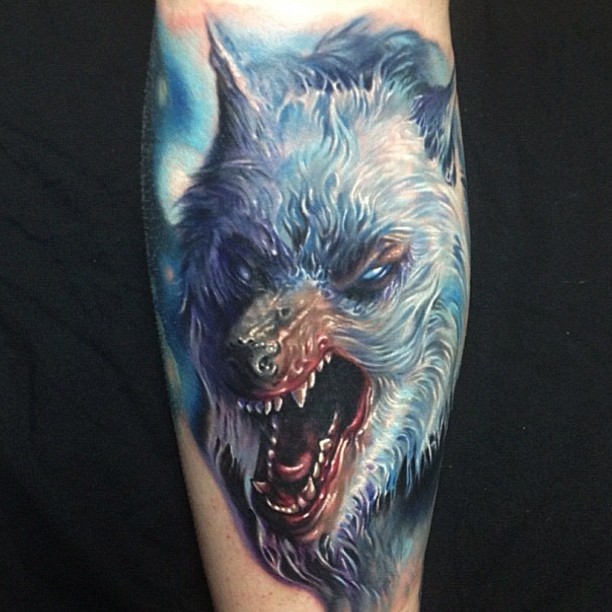 Illustrative style colored forearm tattoo of evil roaring wolf