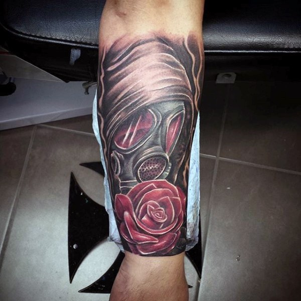 Illustrative style colored forearm tattoo of man in gas mask with rose flower