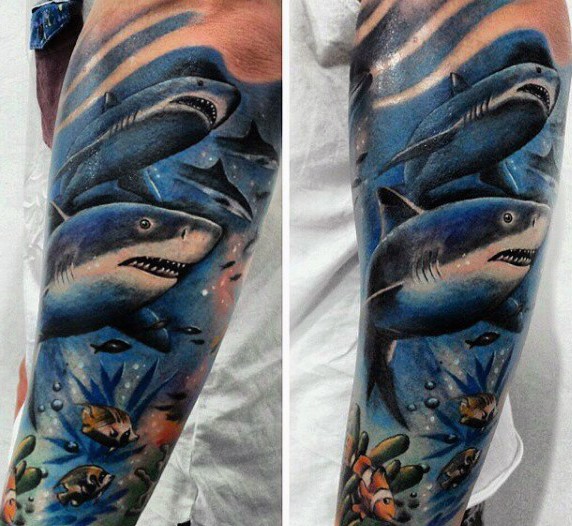 Illustrative style colored forearm tattoo of underwater sharks and fishes