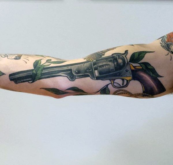 Illustrative style colored forearm tattoo of vintage revolver and flowers