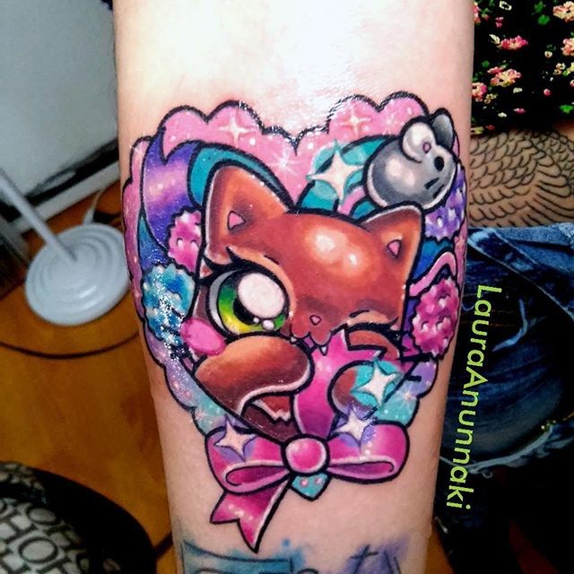 Illustrative style colored forearm tattoo of fantasy cat with stars and bow