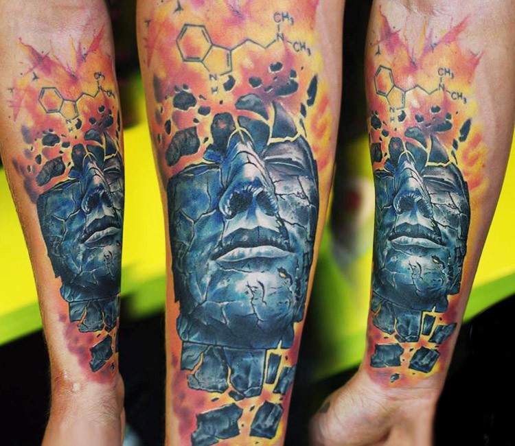Illustrative style colored forearm tattoo of mystical man portrait