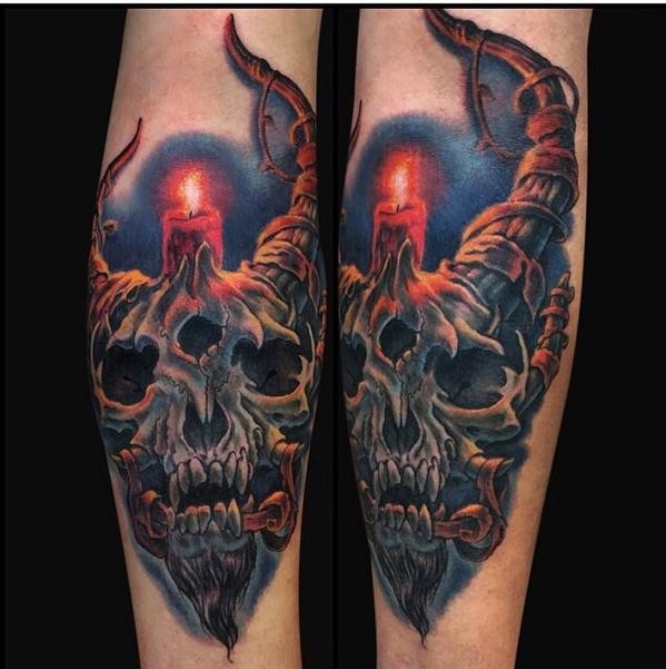 Illustrative style colored forearm tattoo of fantasy devil skull with candle