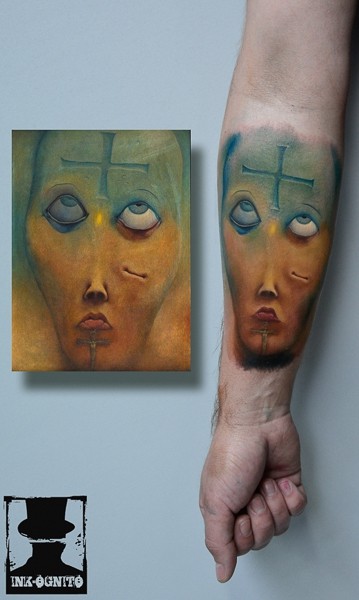 Illustrative style colored forearm tattoo of creepy face with cross