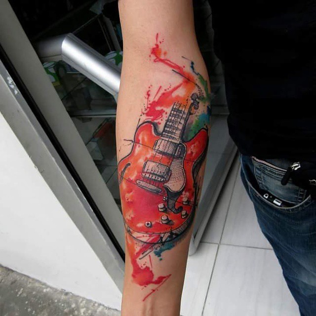Illustrative style colored forearm tattoo of modern guitar