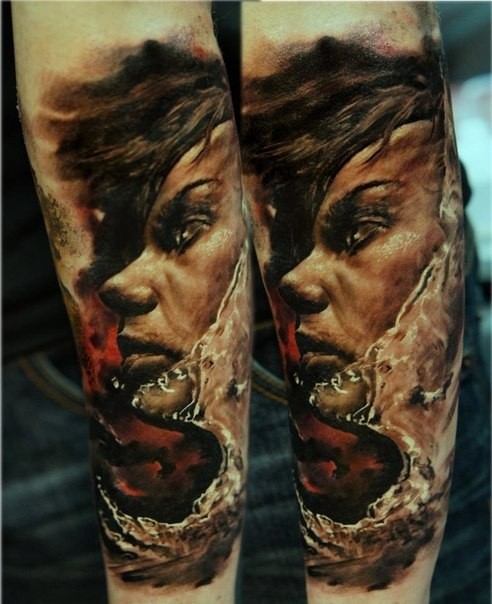 Illustrative style colored forearm tattoo of woman face