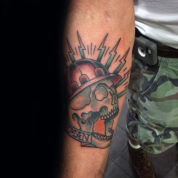 Illustrative style colored forearm tattoo of lineman skull with lettering