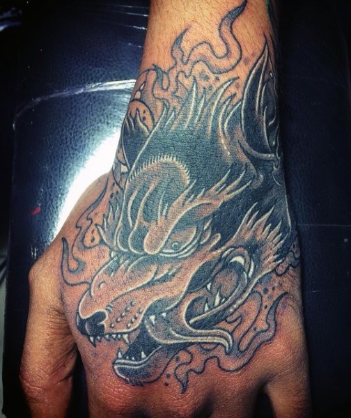 Illustrative style colored hand tattoo of wolf with smoke