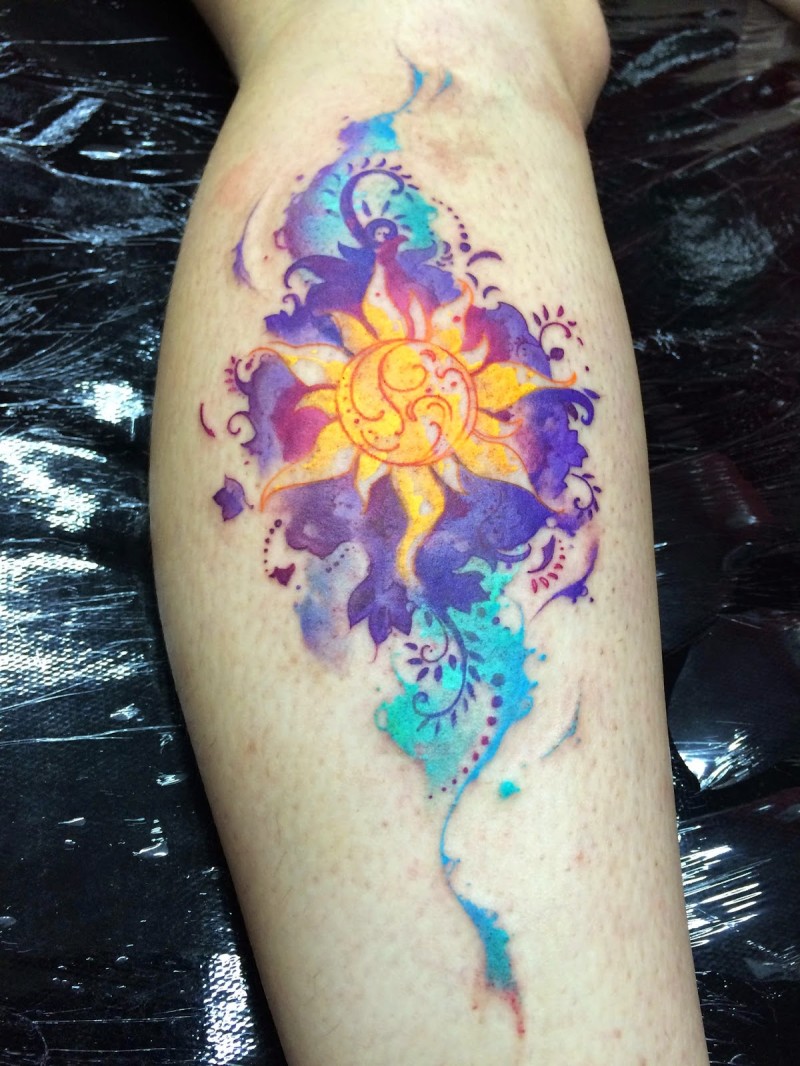 Illustrative style colored leg tattoo of Hinduism style sun