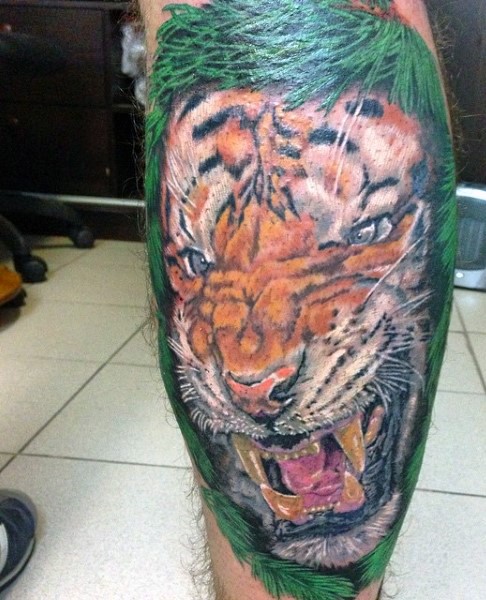 Illustrative style colored leg tattoo of tiger face