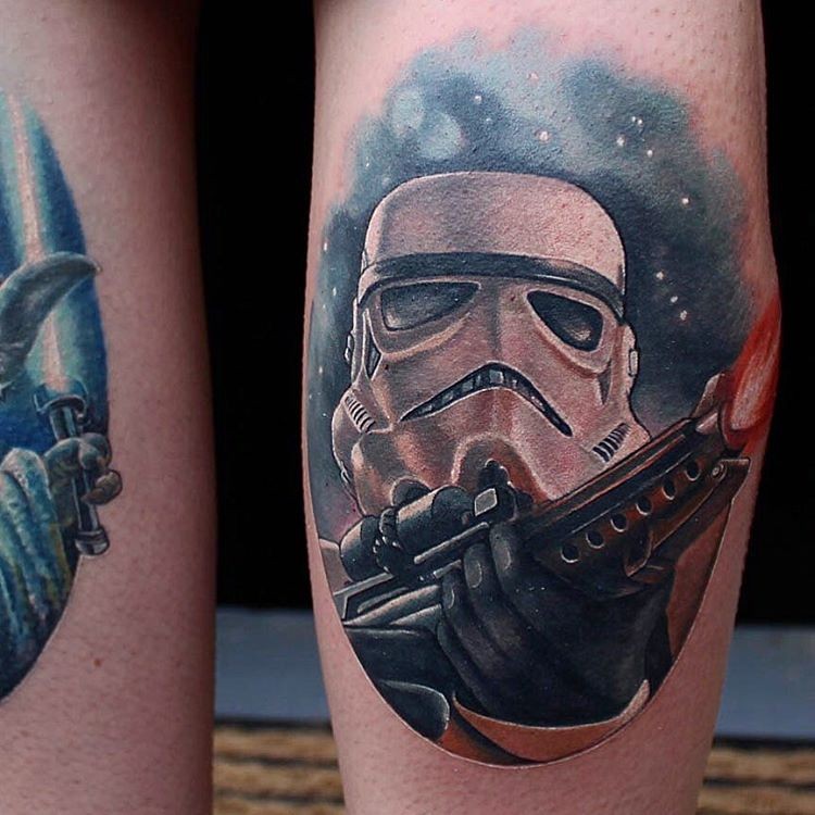 Illustrative style colored leg tattoo of Storm trooper with blaster