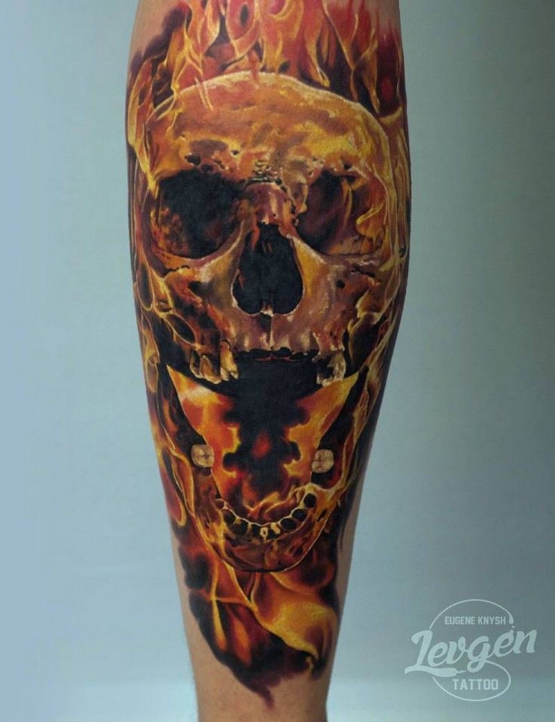 Illustrative style colored leg tattoo of burning skull