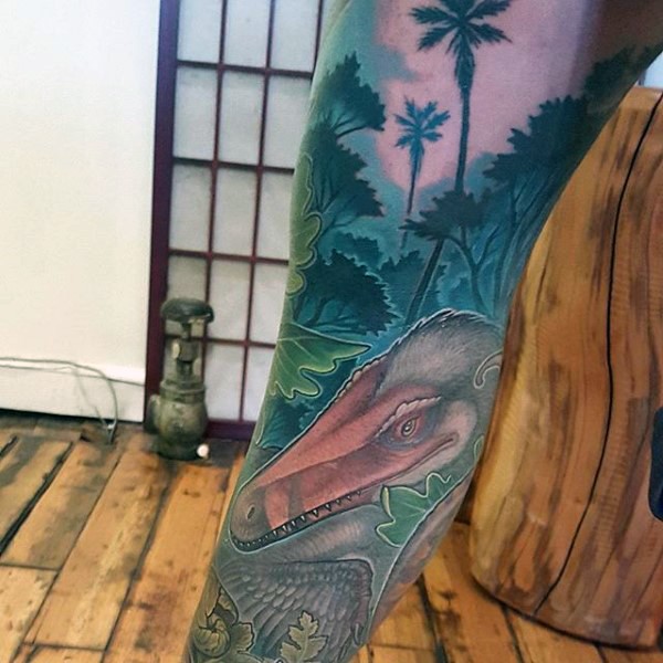 Illustrative style colored leg tattoo of ancient dinosaur