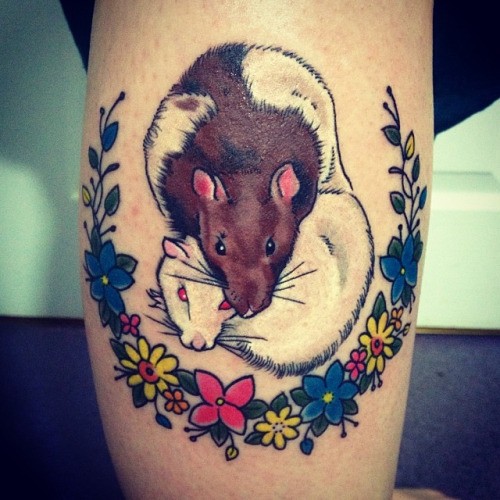 Illustrative style colored leg tattoo of rat couple with flowers