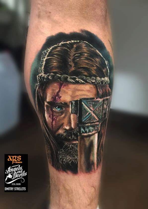 Illustrative style colored leg tattoo of medieval warrior with axe