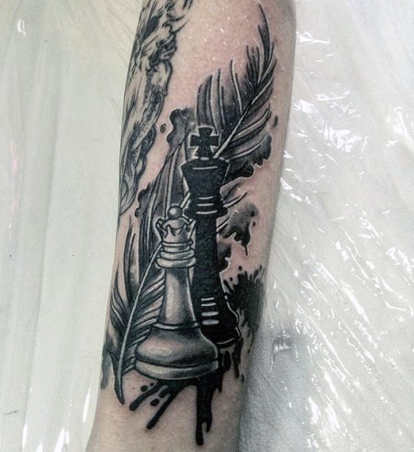 Illustrative style colored leg tattoo of chess figures and feather