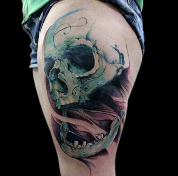 Illustrative style colored mystical skull tattoo on thigh