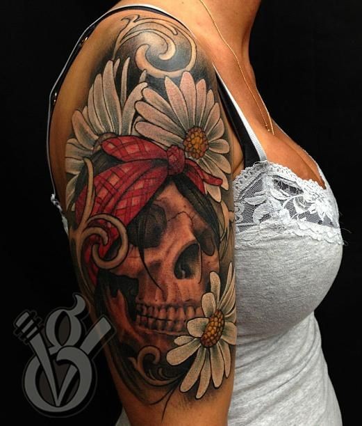 Illustrative style colored shoulder tattoo of human skull with flowers