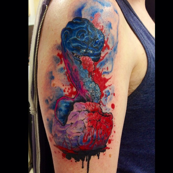 Illustrative style colored shoulder tattoo of bloody snake