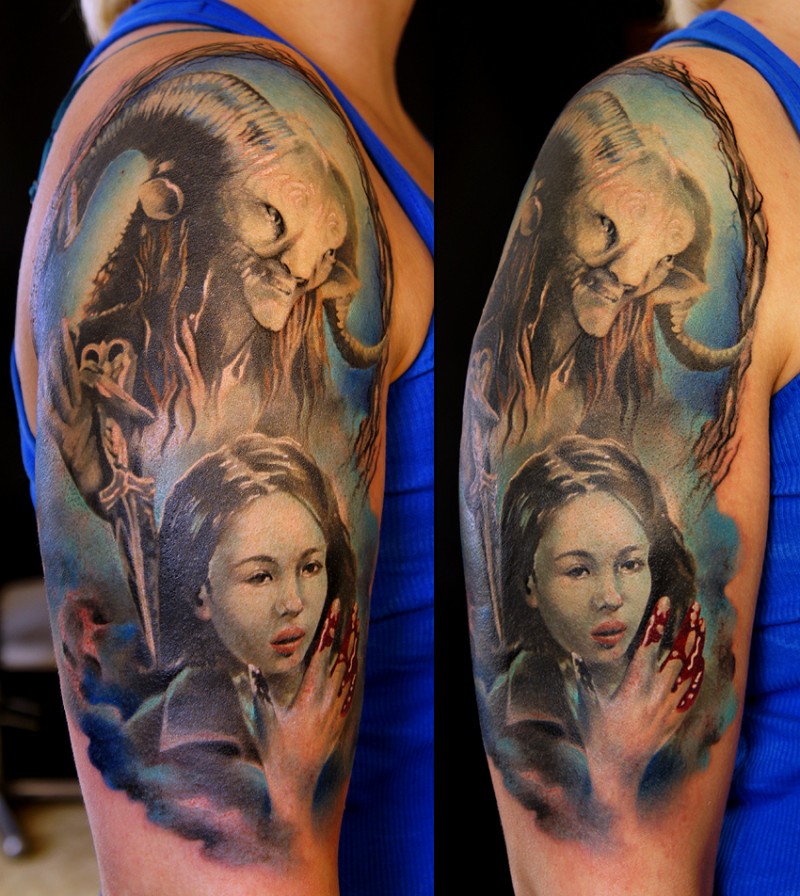Illustrative style colored shoulder tattoo of demon face with bloody woman