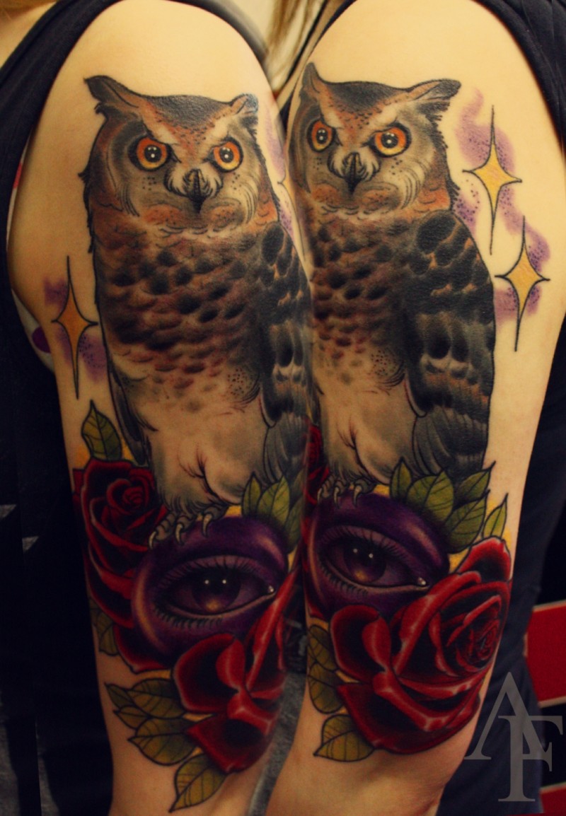Illustrative style colored shoulder tattoo of big owl with stars