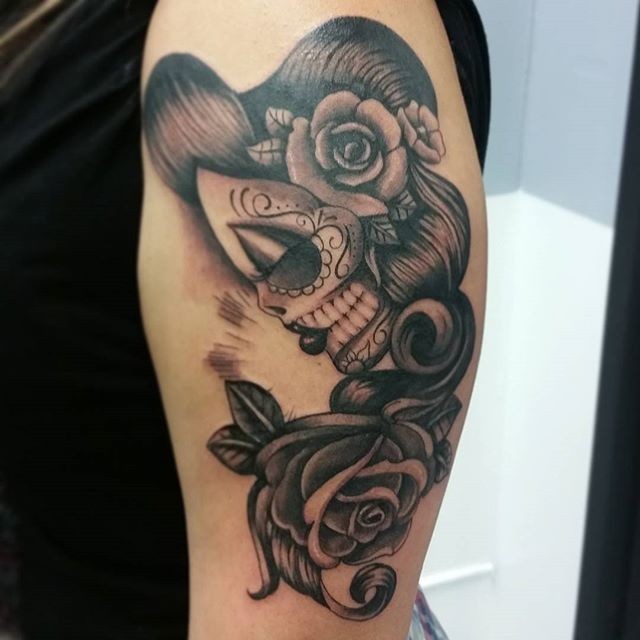 Illustrative style colored shoulder tattoo of Mexican style woman with rose