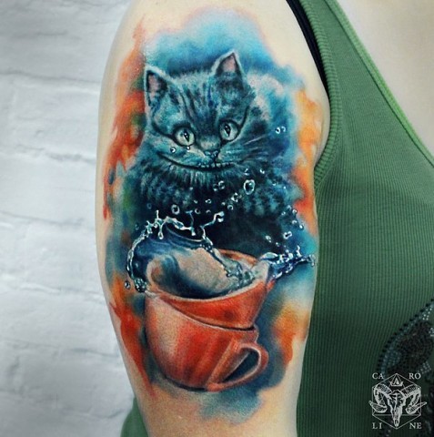 Illustrative style colored shoulder tattoo of Cheshire cat with cup