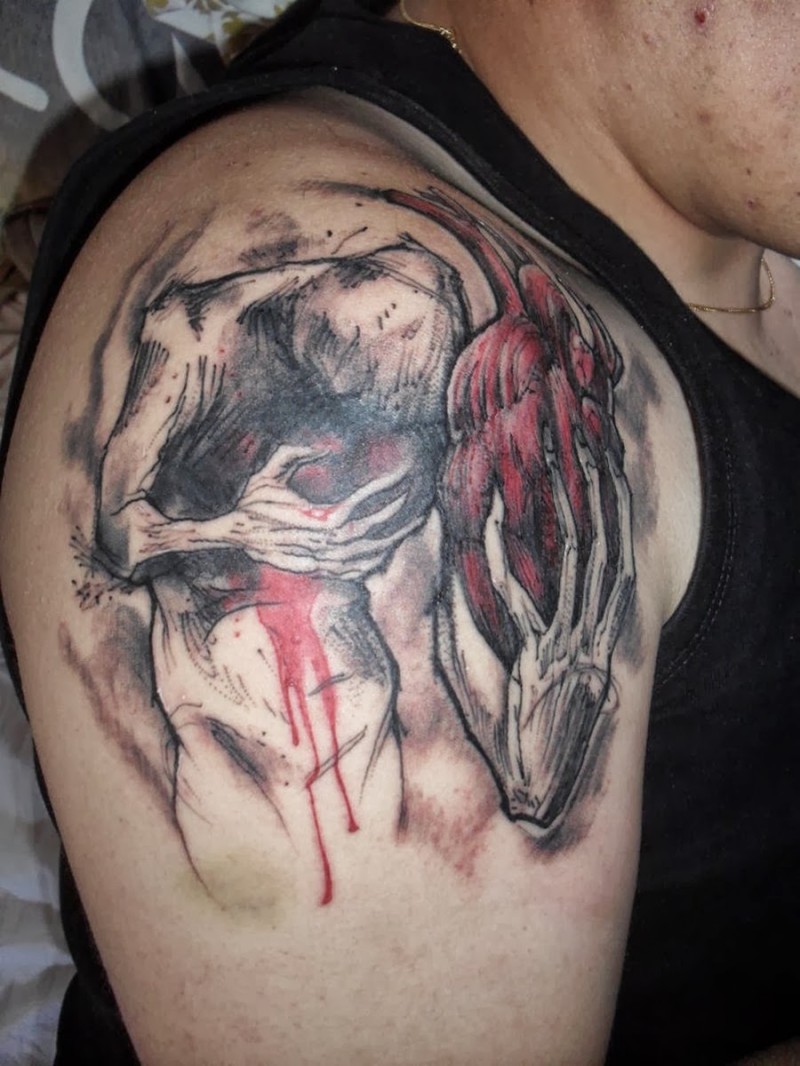 Illustrative style colored shoulder tattoo of creepy monster with human heart