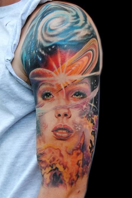 Illustrative style colored shoulder tattoo of woman face in space