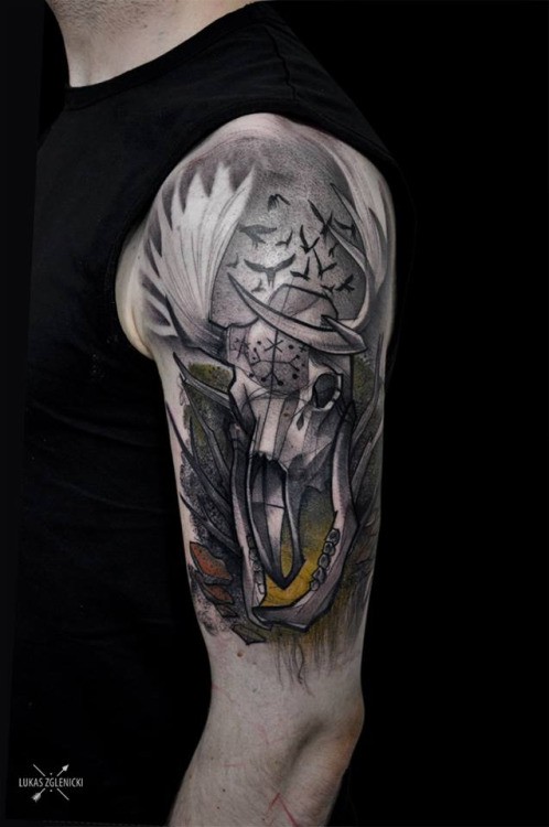 Illustrative style colored shoulder tattoo of interesting looking animal skull with birds