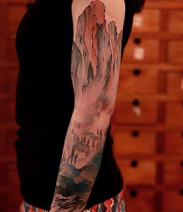 Illustrative style colored sleeve tattoo of mountains with forest