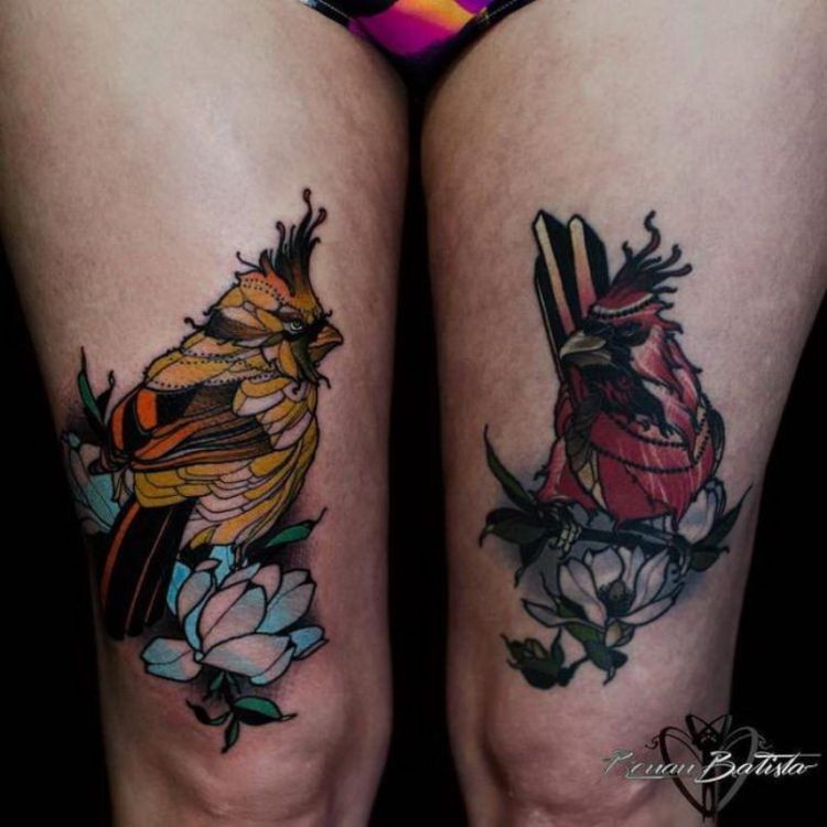 Illustrative style colored thigh tattoo of bird with flowers