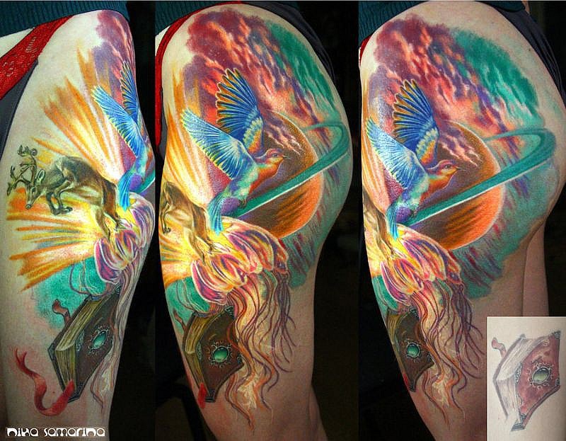 Illustrative style colored thigh tattoo of flying fantasy bird and planet