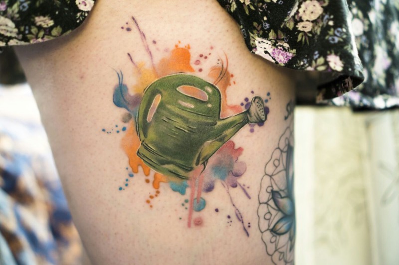 Illustrative style colored thigh tattoo of watering can