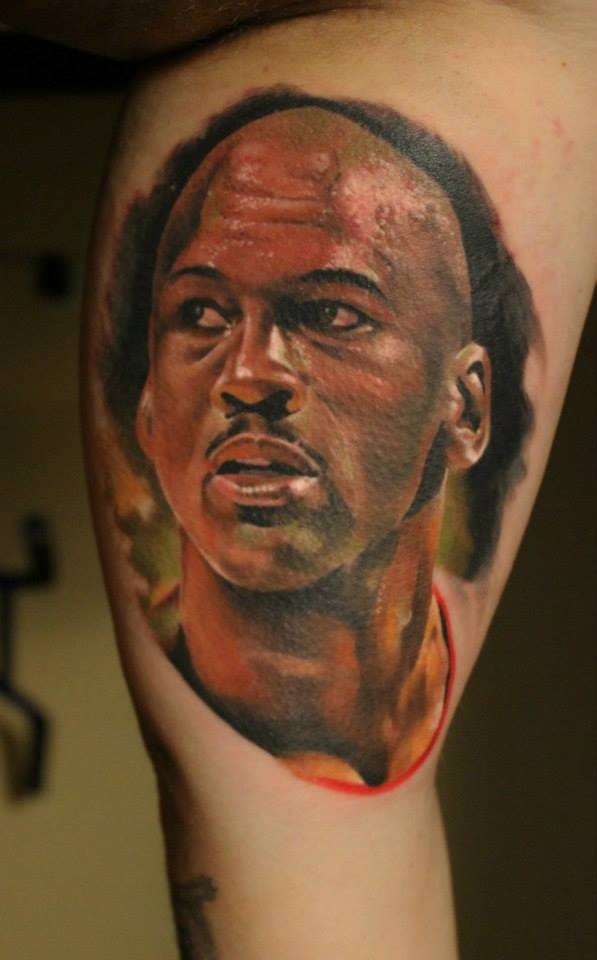 Illustrative style colored thigh tattoo of Jordan face