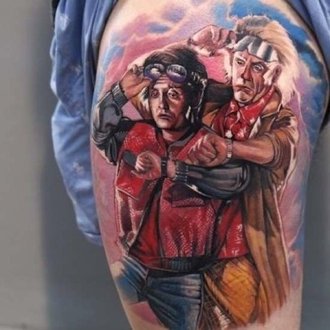 Illustrative style colored thigh tattoo of famous movie heroes