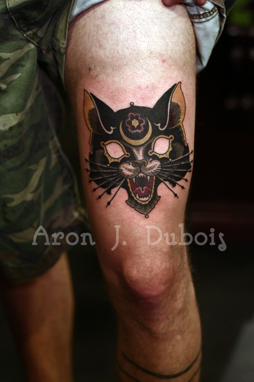 Illustrative style colored thigh tattoo of fantasy cat mask