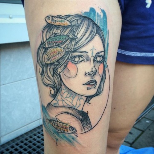 Illustrative style colored thigh tattoo of woman face with fishes