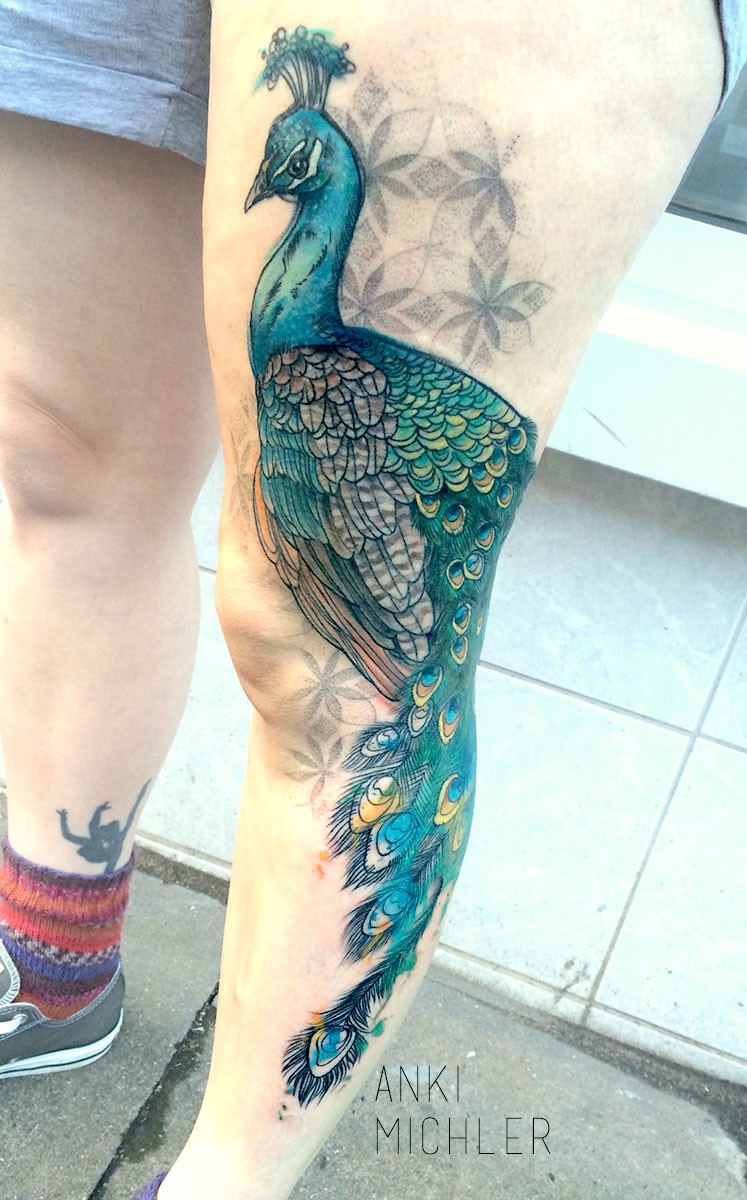 Illustrative style colored thigh tattoo of big peacock