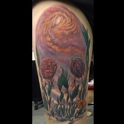 Illustrative style colored thigh tattoo of flowers and night sky