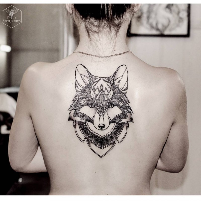 Illustrative style colored upper back tattoo of fantasy wolf
