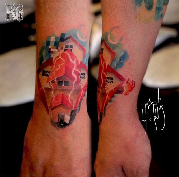Illustrative style colored wrist tattoo of house with lightning