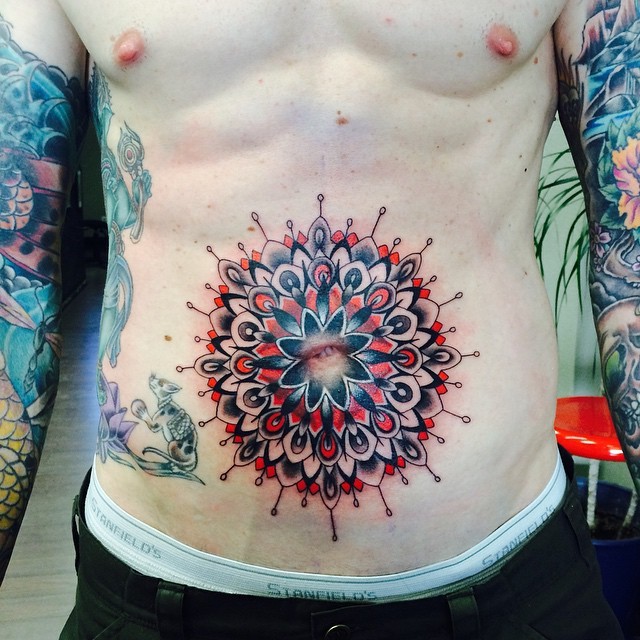 Illustrative style colorful flower tattoo on belly