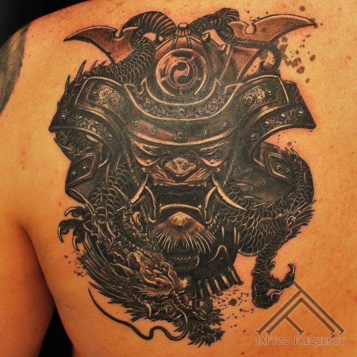 Illustrative style detailed scapular tattoo of large samurai mask and dragon