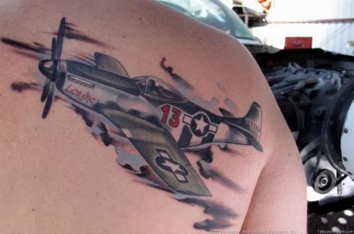 Illustrative style realistic looking scapular tattoo of WW2 fighter plane