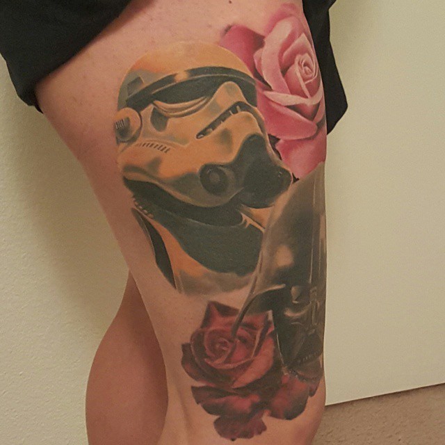 Illustrative style thigh tattoo of Storm trooper with Darth Vader and flowers