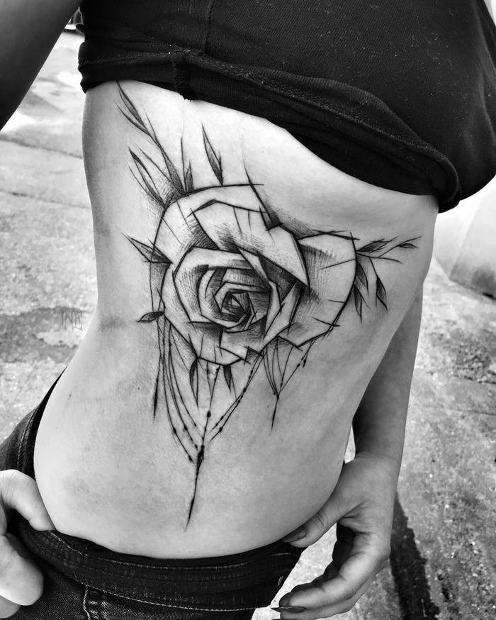 Impressive big black ink rose tattoo painted by Inez Janiak on side