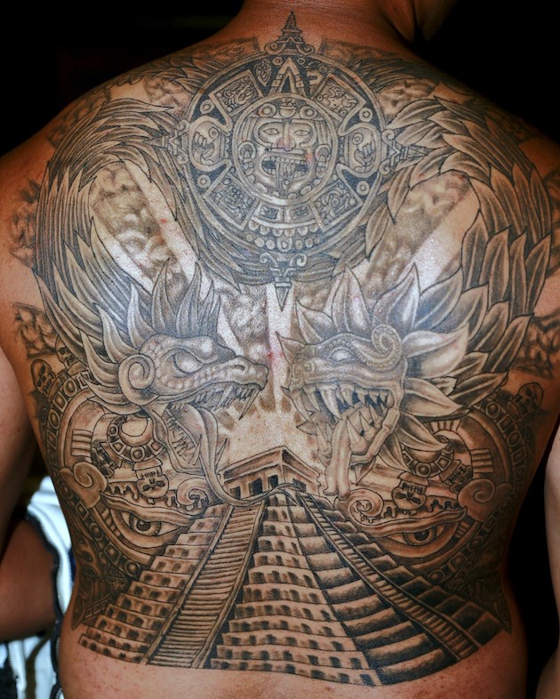 Impressive black and white massive on whole back tattoo of Mayan themed