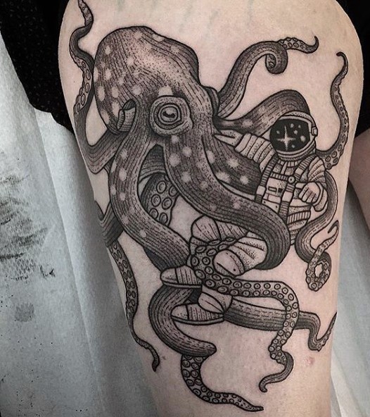 Impressive black and white octopus with astronaut tattoo on thigh