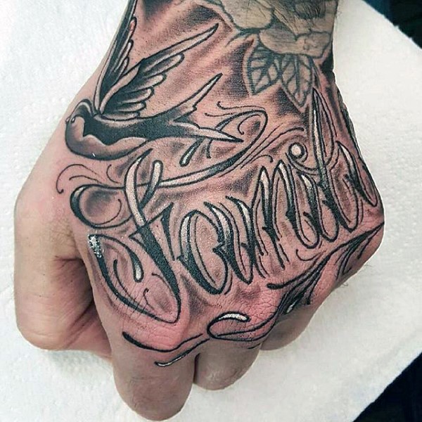 Impressive design lettering family tattoo on hand with swallow